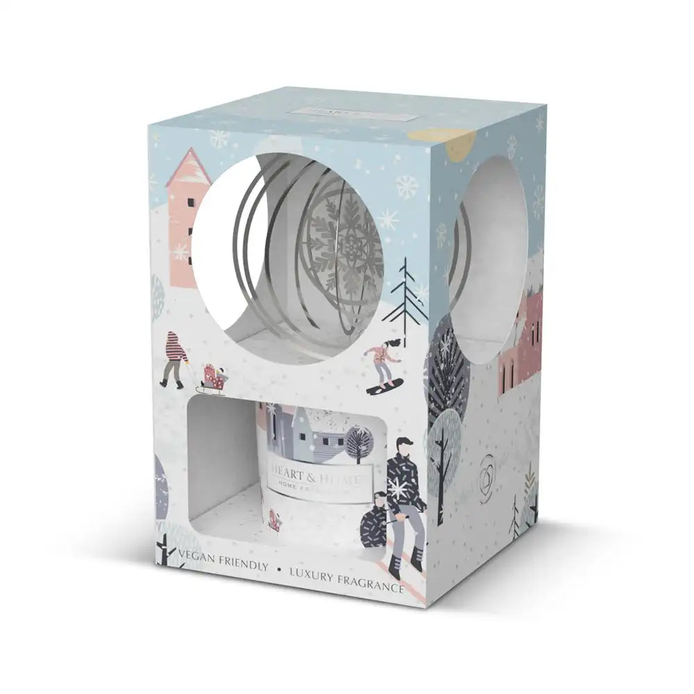 Candle packaging with winter-themed design on a white background