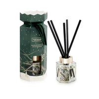 Heart & Home Christmas Fragrance Diffuser set featuring a dark green gift box with a gold cap and reeds, alongside the clear glass diffuser bottle with black reeds and a gold collar, on a white background.
