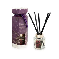 A reed diffuser set from featuring a purple gift box with gold star details and a clear glass bottle with black reeds, shown on a white background.