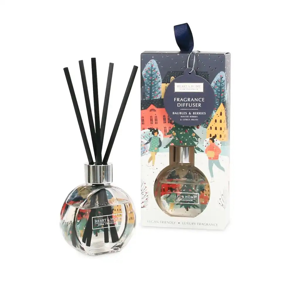 Fragrance diffuser with black sticks and decorative packaging on a white background