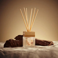 Diffuser with wooden sticks on a neutral background