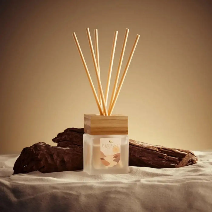 Diffuser with wooden sticks on a neutral background