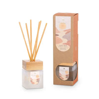 Reed diffuser with packaging on a white background