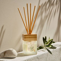 Reed diffuser with frosted glass and bamboo lid and reeds 