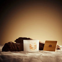 Candle and wooden box on a textured surface with a warm glow