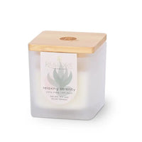 Candle in a white container with a wooden lid on a white background