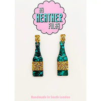 Teal and gold bottle-shaped earrings with 'By Heather Filby' branding on a white background.