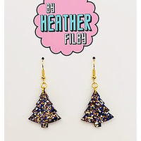 Tree-shaped earrings with glittery finish on a 'By Heather Filby' branded card.