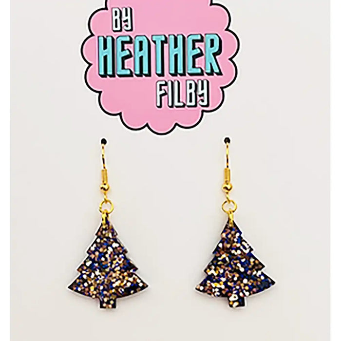 Tree-shaped earrings with glittery finish on a 'By Heather Filby' branded card.