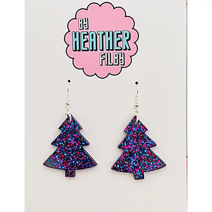 Tree-shaped earrings with multicolor glitter on a card with 'By Heather Filby' branding.