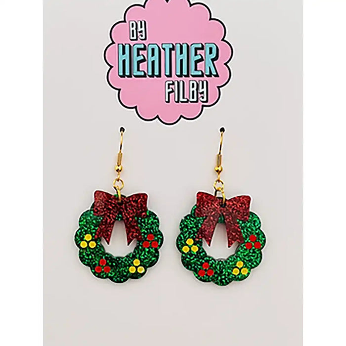 Christmas wreath earrings with red bows on a card with 'By Heather Filley' branding.