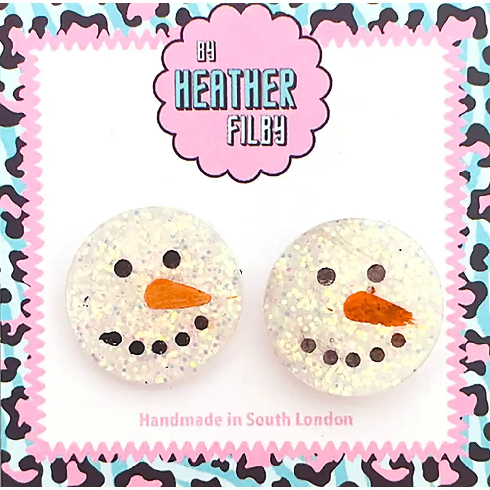 Pair of snowman-shaped earrings with a colorful patterned border, featuring the brand 'Heather Filby'.