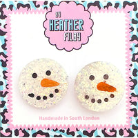 Pair of snowman-shaped earrings with a colorful patterned border, featuring the brand 'Heather Filby'.