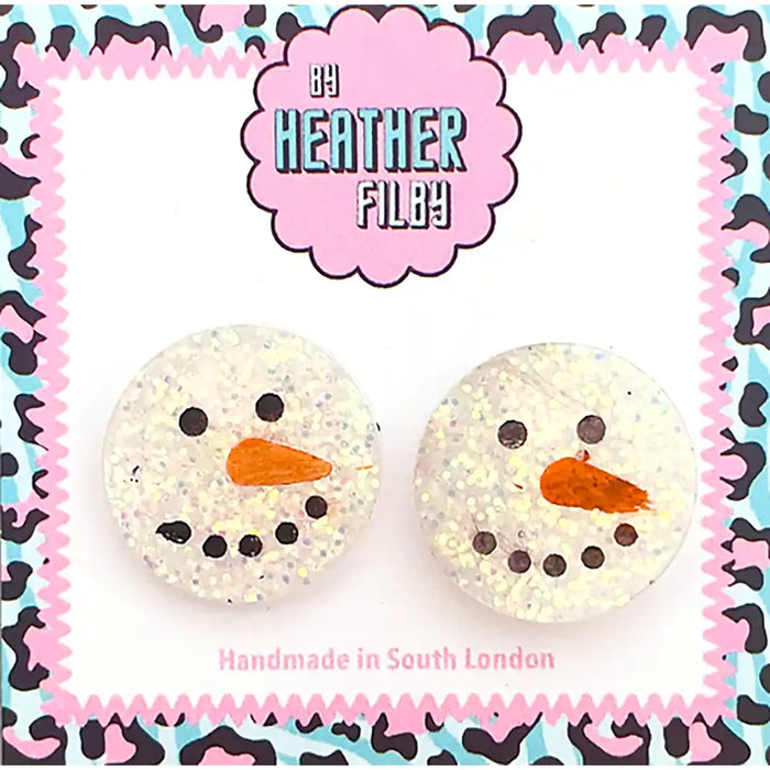 Pair of snowman-shaped earrings with a colorful patterned border, featuring the brand 'Heather Filby'.