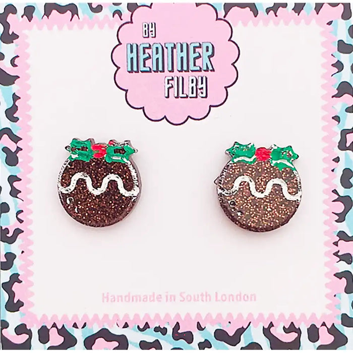 Pair of festive pudding earrings on a patterned card with 'Heather Filby' branding.