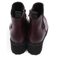 Pair of plum  ankle boots on a white background showing the back and the tab