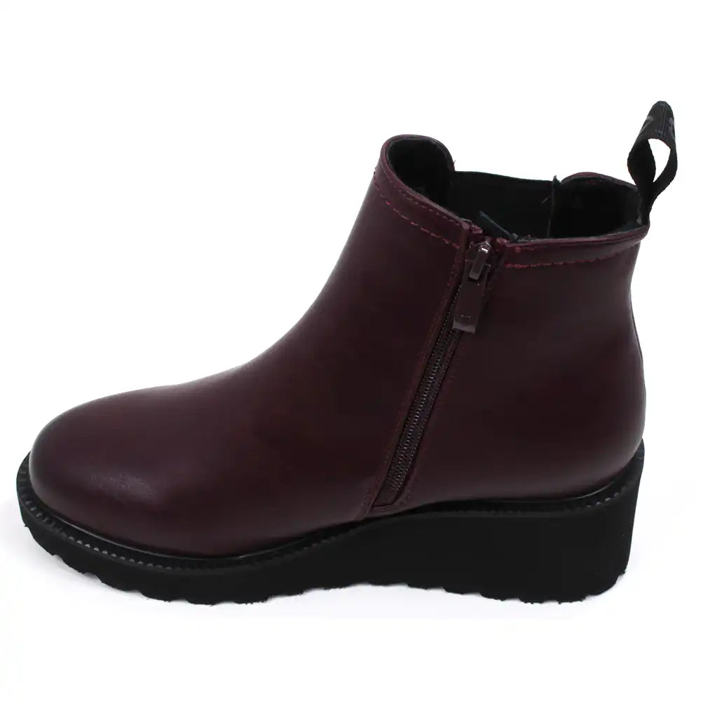 Single plum ankle boot with a black  wedge sole on a white background showing the full side zip.