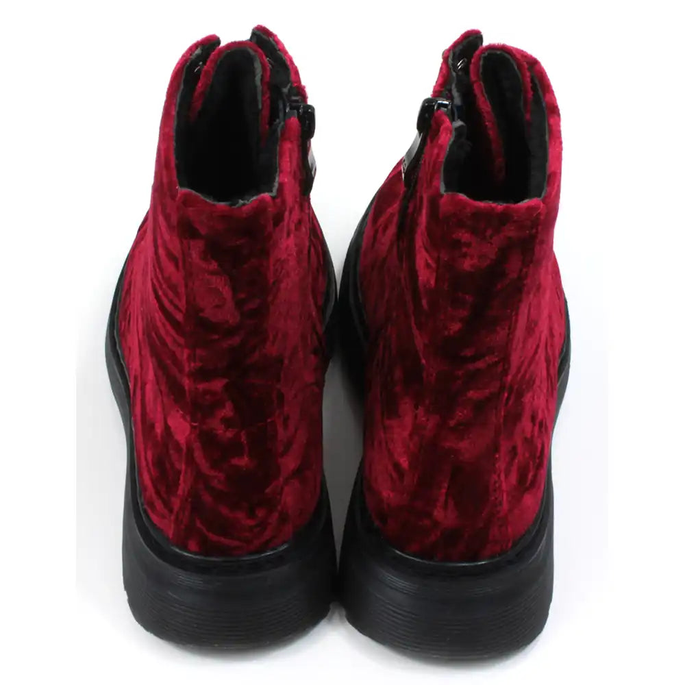Red velour combat boots with rugged black soles and 8 hole laces. Fitted using zips. Back view.