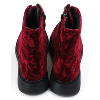 Red velour combat boots with rugged black soles and 8 hole laces. Fitted using zips. Back view.