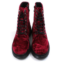 Red velour combat boots with rugged black soles and 8 hole laces. Fitted using zips. Front view.