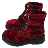 Red velour combat boots with rugged black soles and 8 hole laces. Fitted using zips. Side view.