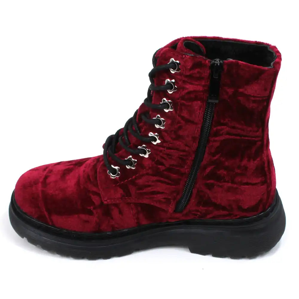 Red velour combat boot with rugged black sole and 8 hole laces. Fitted using zips. View showing zip.