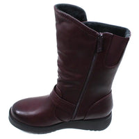 Burgundy calf height boot with buckles at the ankle and on the leg. Low heels. View showing the zip fitting.