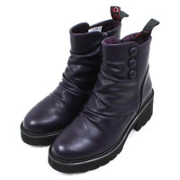 Purple ankle boots with three buttons detail on the ankles. Low black rubber heels. Angled view.