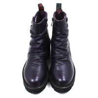 Purple ankle boots with three buttons detail on the ankles. Low black rubber heels. Front view.