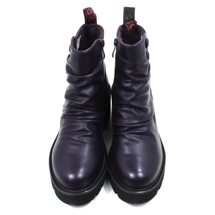 Purple ankle boots with three buttons detail on the ankles. Low black rubber heels. Front view.