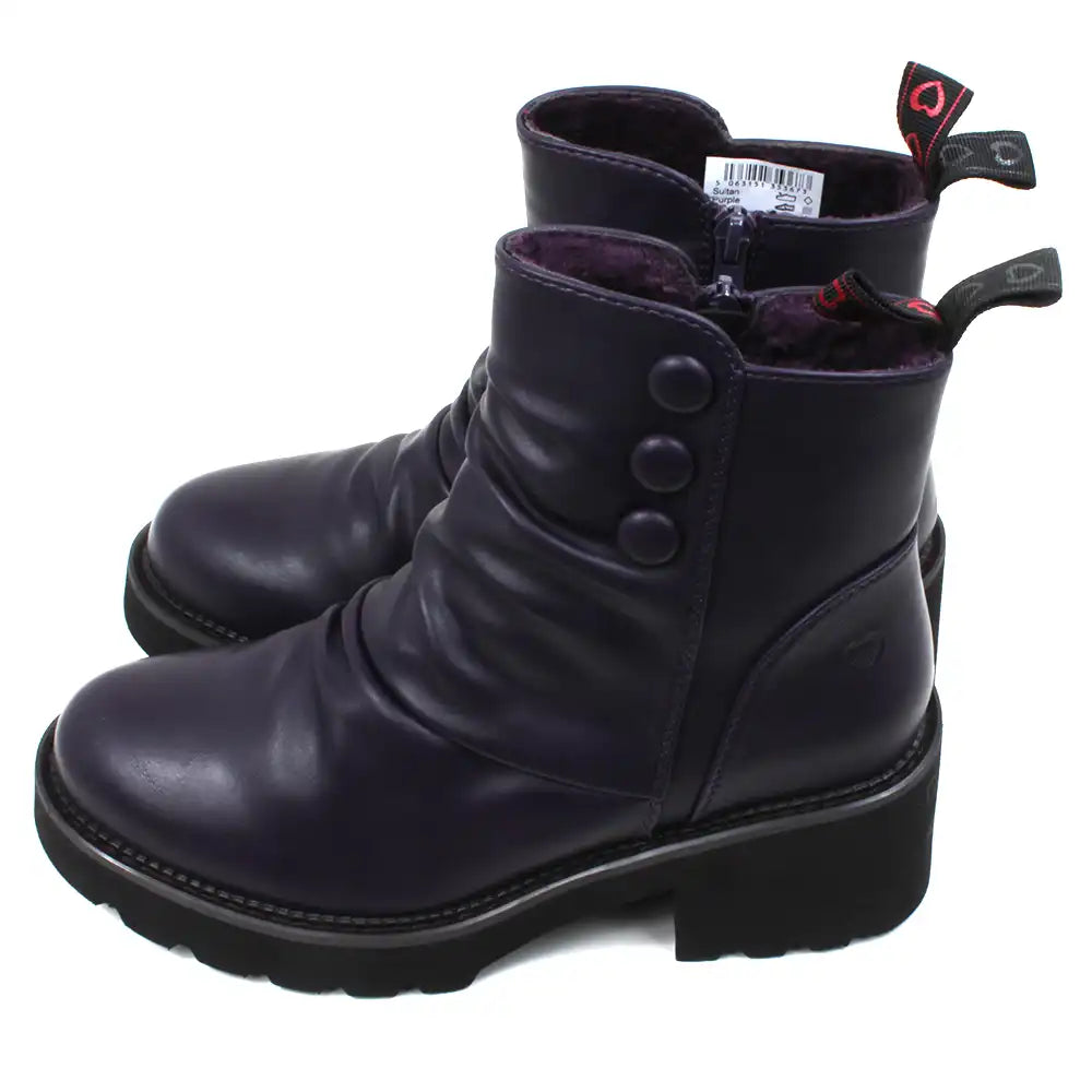 Purple ankle boots with three buttons detail on the ankles. Low black rubber heels. Side view.