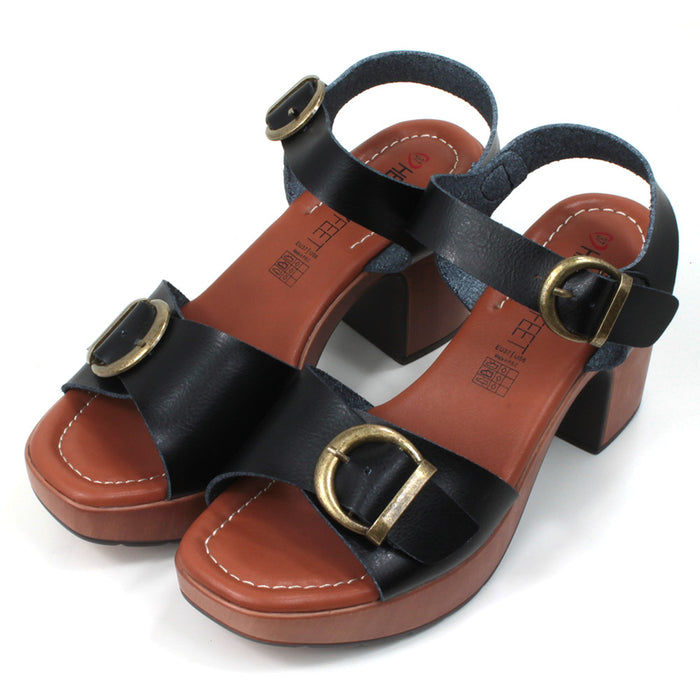 Heavenly Feet black strappy, chunky sandals with antique gold effect buckles. High heels and padded insoles. Angled view.