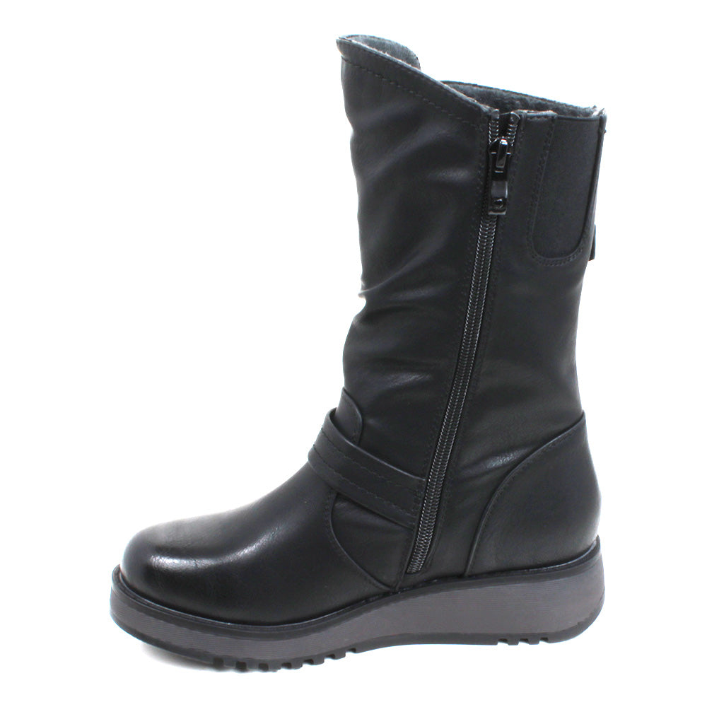 Heavenly Feet Hannah calf boots in black. Strap and buckle across the ankle and around the calf. Low wedge soles in black. Single boot view showing zip fastening.