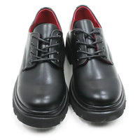 A pair of black leather lace-up shoes with chunky black soles and a bright red interior lining, shown against a plain white background.