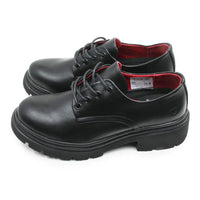 A pair of black leather lace-up shoes with a chunky lug sole and a bright red interior lining, shown against a plain white background.