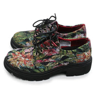 A pair of lace-up platform shoes featuring a vibrant, multicolor floral and butterfly print on a canvas-like upper, with black laces and thick black platform soles.