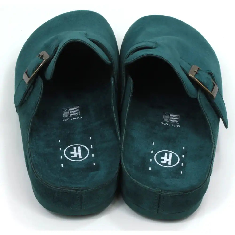 Pair of green slippers with buckles on a white background