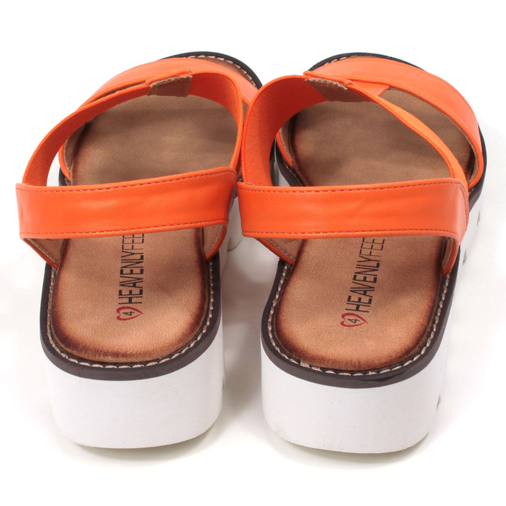 Orange low wedge sandals from Heavenly Feet. Over toes strap and upper foot elasticated strap. Strap around the back of the heel. Tan coloured footbeds. White low wedge soles with wide deep carved tread. Back view.