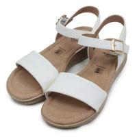 White sandals with gold buckles on a white background