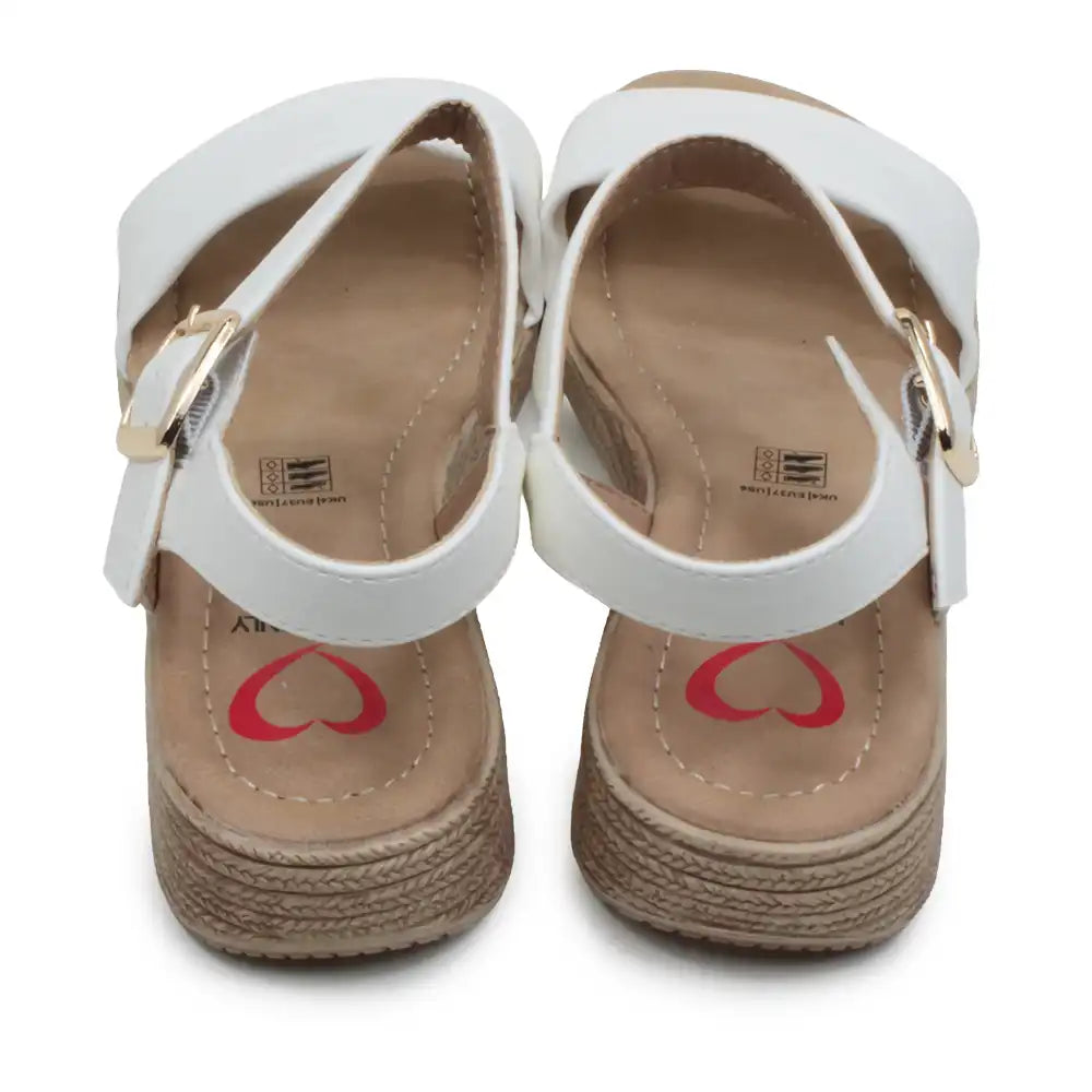White sandals with gold straps and red hearts on a white background