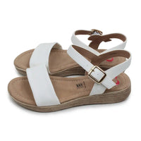 Pair of sandals with white straps and brown soles on a white background