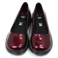 Pair of patent maroon slip on shoes with black low wedge soles. Round toes. Front view.
