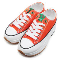Orange sneakers with white laces on a white background