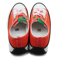 Pair of red sneakers with white laces on a white background