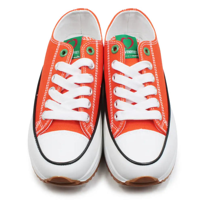 Pair of orange sneakers with white laces on a white background