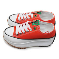 Red sneakers with white soles on a white background