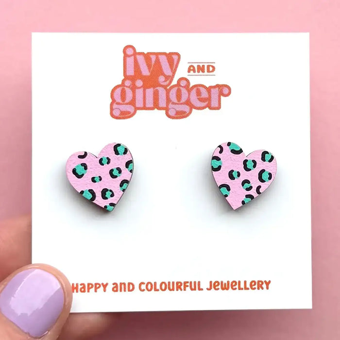 Heart-shaped earrings with leopard print design on a 'ivy and ginger' branded card.