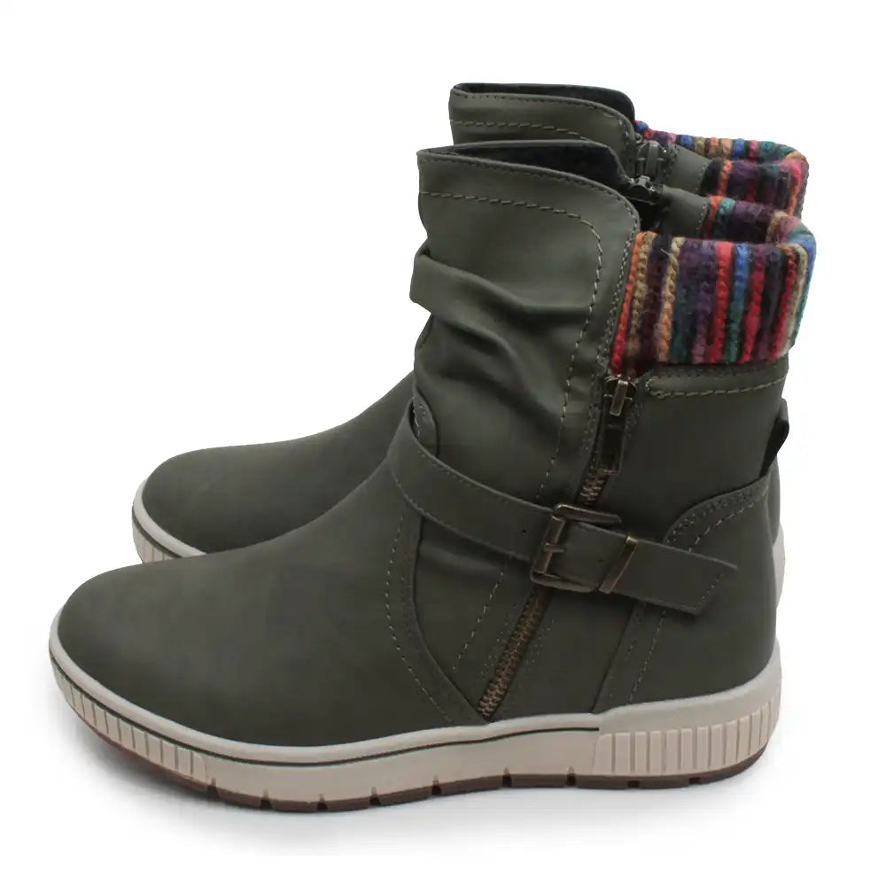 A pair of women's mid-calf boots in olive green faux leather, featuring a side zipper, a buckle strap, and a colorful striped knit lining visible at the collar, set against a plain white background.