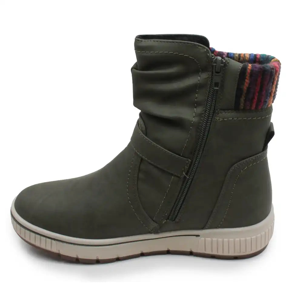 An olive green ankle boot with a side zipper, a slouchy upper, and a multicolor striped knit lining visible at the collar, set against a plain white background.