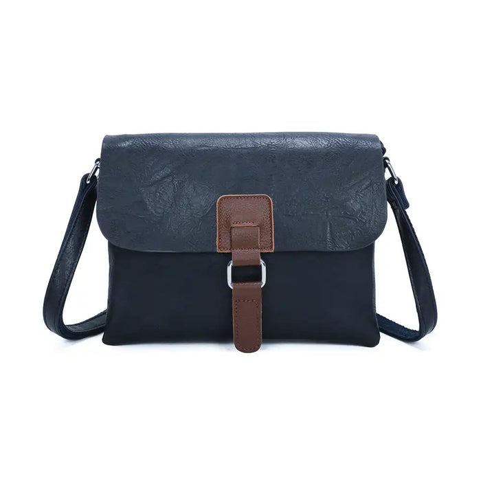 Navy satchel bag with a brown tab and silver hoop detail. On a white background 